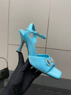Light blue ladies heeled mule-style sandal with jeweled buckle and open toe.