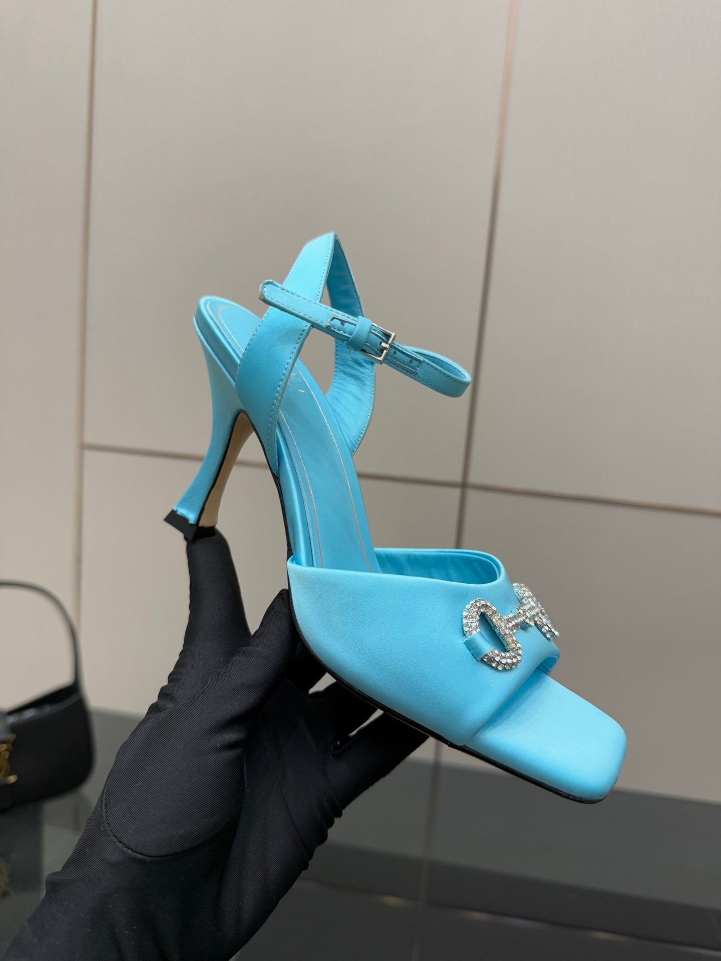 Light blue ladies heeled mule-style sandal with jeweled buckle and open toe.