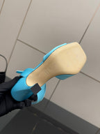 Light blue ladies sandal outsole close-up with strap and low-heel underside.