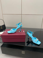 Light blue ladies heeled sandals with jeweled buckle and slim high heel, open toe.