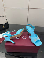 Light blue ladies heeled sandals with jeweled buckle ornament on the strap.