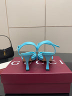 Light blue ladies heeled sandals, top view showing ankle strap and jeweled buckle.