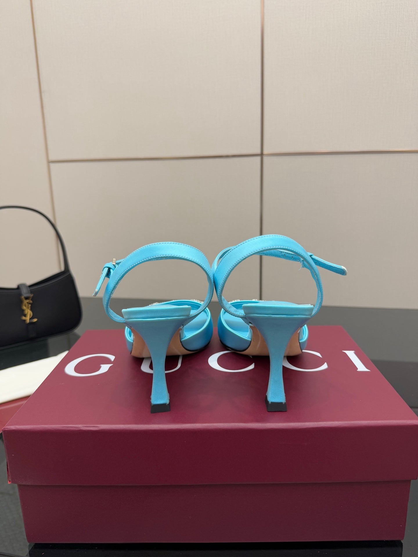 Light blue ladies heeled sandals, top view showing ankle strap and jeweled buckle.