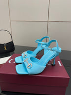 Light blue ladies heeled sandals with jeweled buckle detail and wide ankle strap.