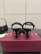 Gucci ladies open-toe heeled sandal back view, black straps and slim heel