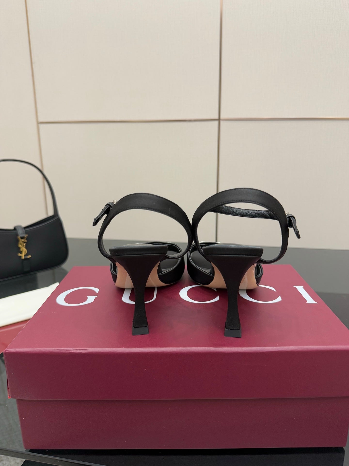 Gucci ladies open-toe heeled sandal back view, black straps and slim heel