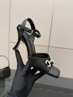 Gucci ladies open-toe heeled sandal close-up, black upper with silver-tone logo