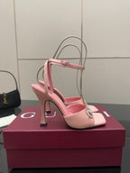 Gucci ladies pink satin heels with open toe, rhinestone buckle, and thin ankle straps