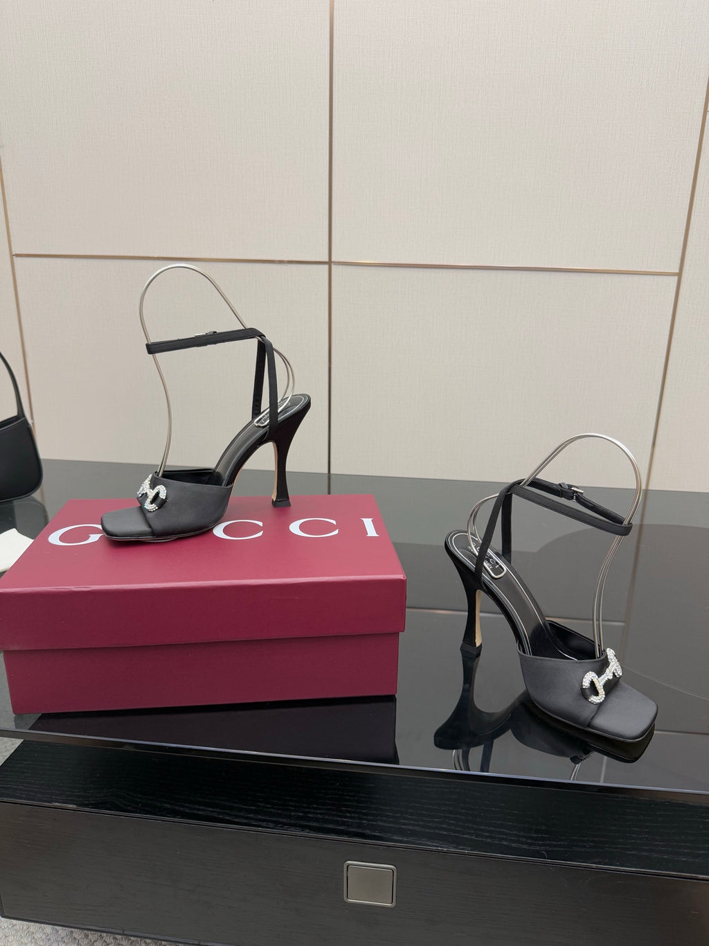 Gucci ladies black heeled sandals with silver-tone buckles and open-toe silhouette
