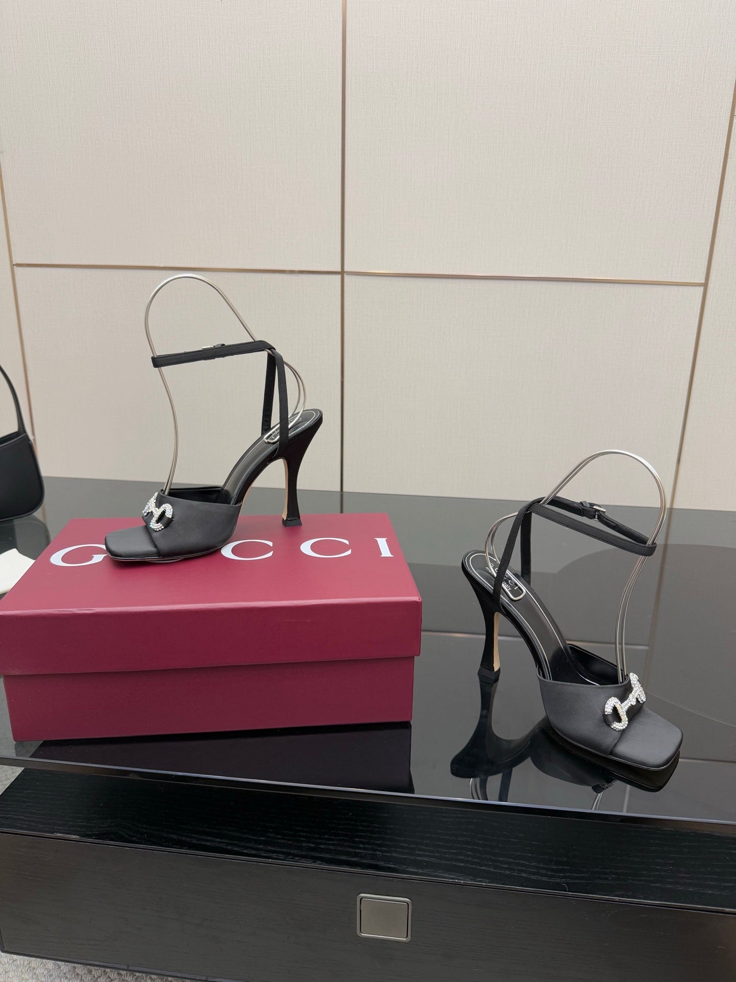 Gucci ladies black heeled sandals with silver-tone buckles and open-toe silhouette