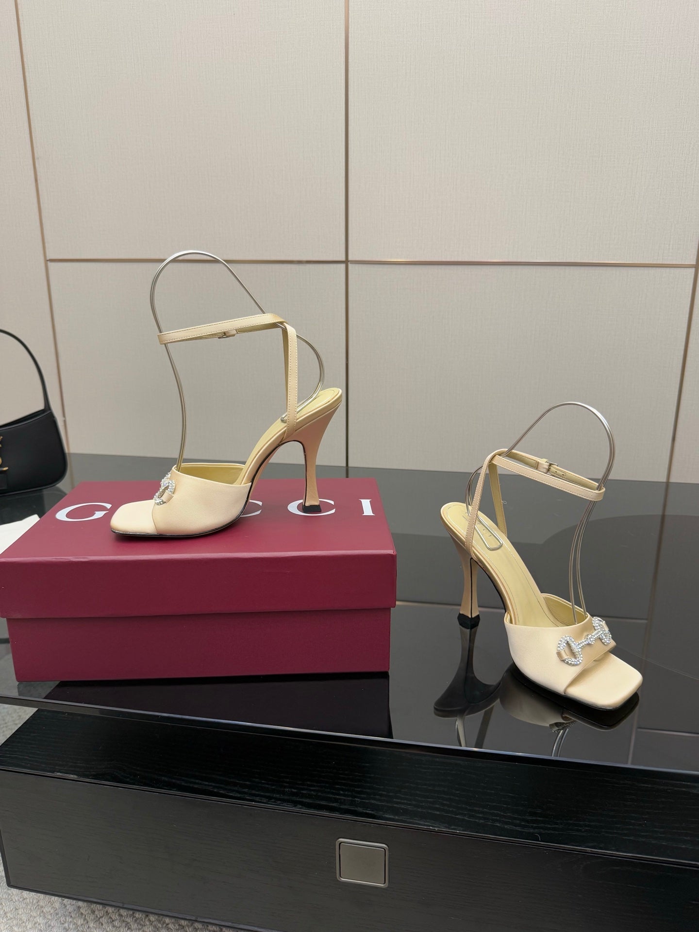 Cream stiletto heeled sandals with rhinestone strap and open toe