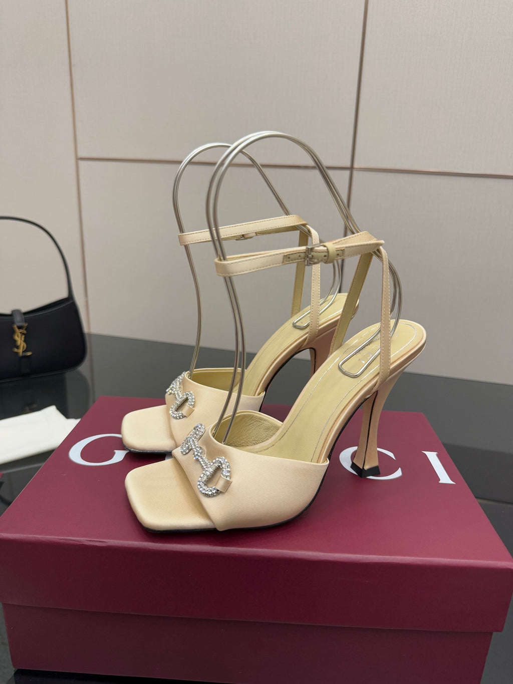 Cream strappy slingback sandals with open back, rhinestone ankle detail, stiletto heel