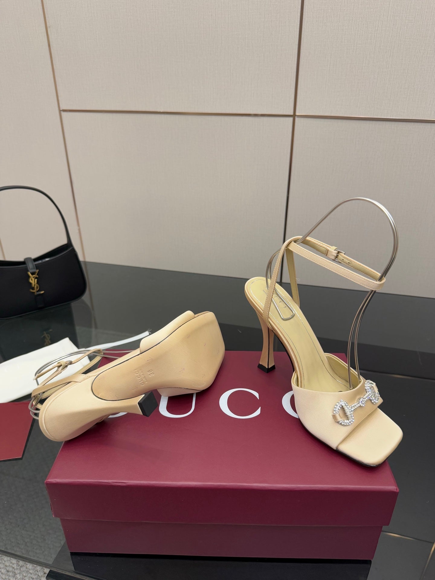 Cream slingback sandals with rhinestone buckle strap and slender stiletto heel