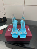 Women’s sky-blue heeled sandals with ankle straps and decorative gold-tone hardware