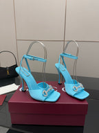 Women’s sky-blue heeled sandals with open toe, ankle strap, and gold-tone ornament