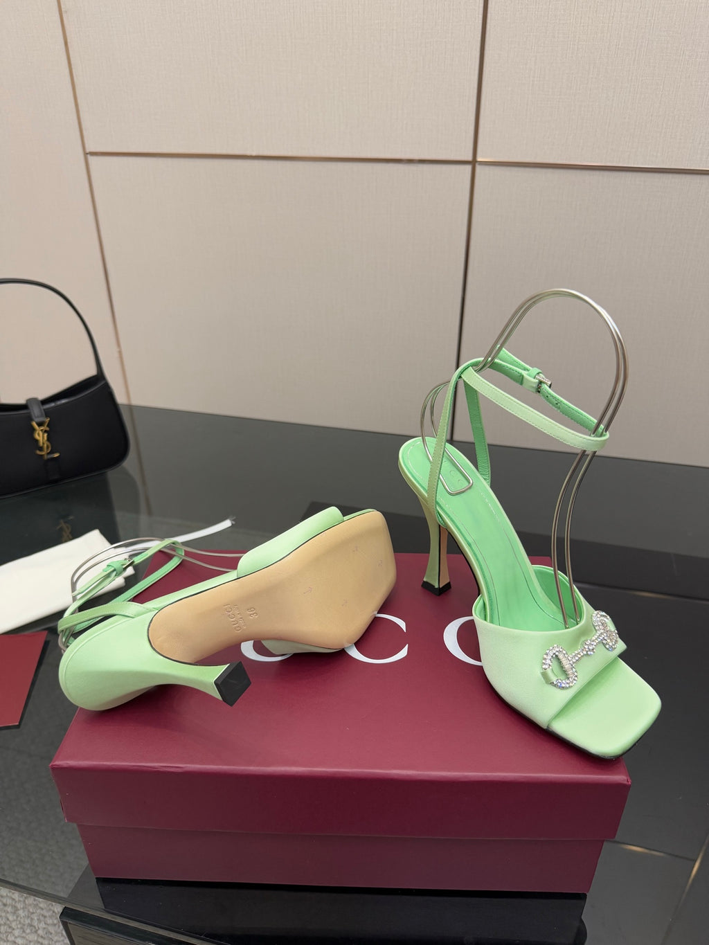 Green open-toe heeled sandal pair with slingback strap and silver-tone buckle detail