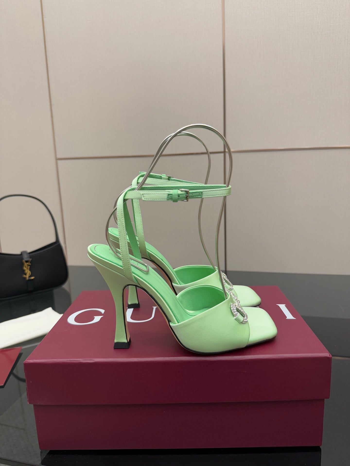 Green open-toe heeled sandal with slingback strap and silver-tone buckle detail