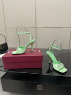 Green open-toe heeled sandals with thin ankle strap and silver-tone buckles