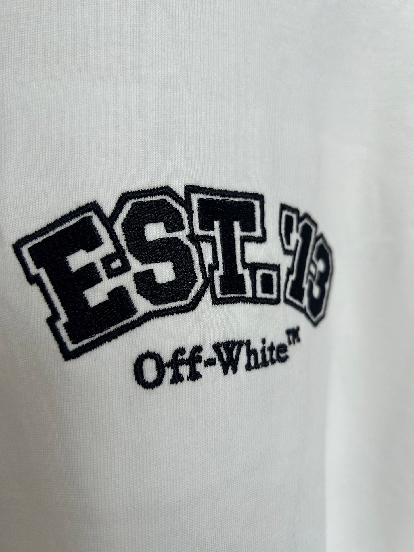 Off-White off-white T-shirt showing EST. 19 “Off-White” logo close-up