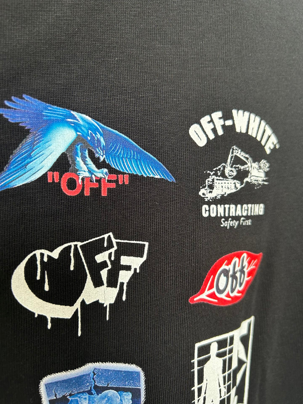 Off-White black T-shirt close-up with blue wing graphic and OFF-WHITE contracting text