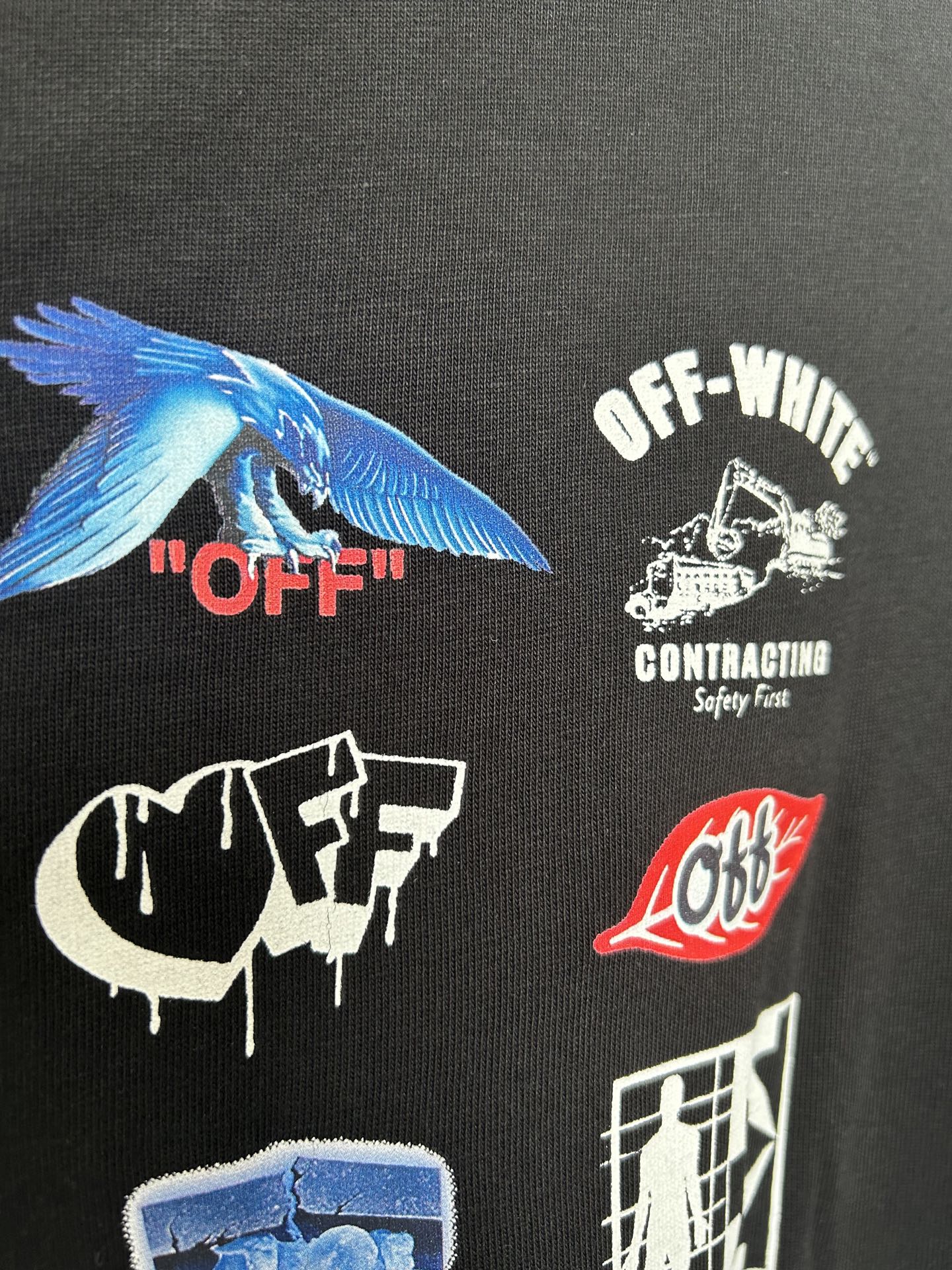 Off-White black T-shirt close-up with blue wing graphic and OFF-WHITE contracting text