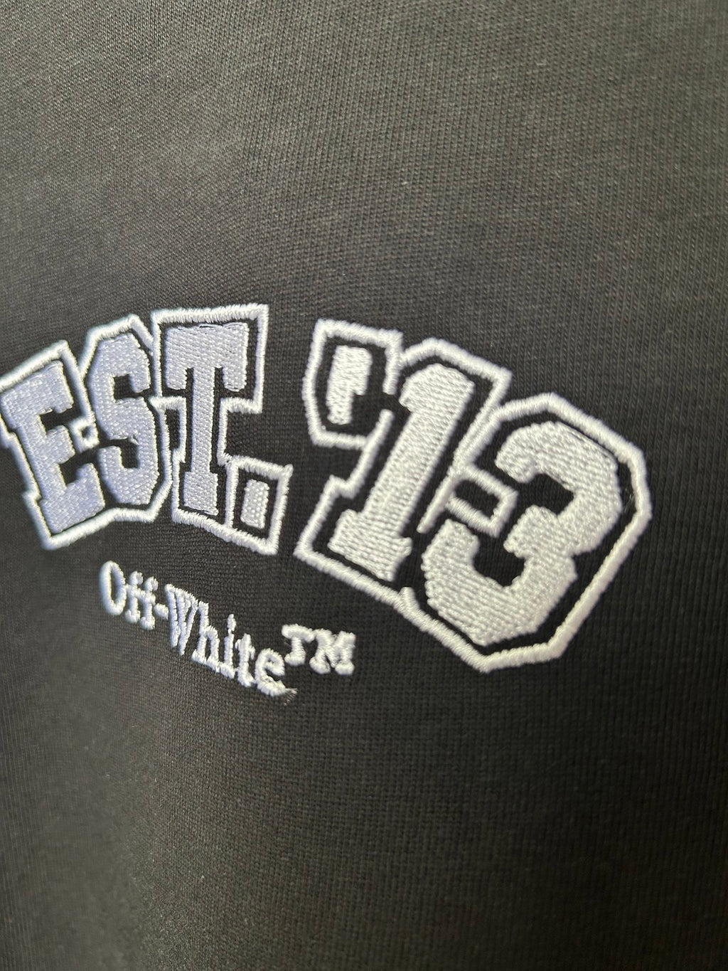Off-White black T-shirt close-up of EST. 1970 graphic with Off-White text