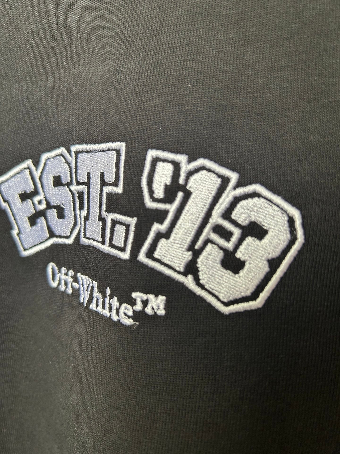 Off-White black T-shirt close-up of EST. 1970 graphic with Off-White text