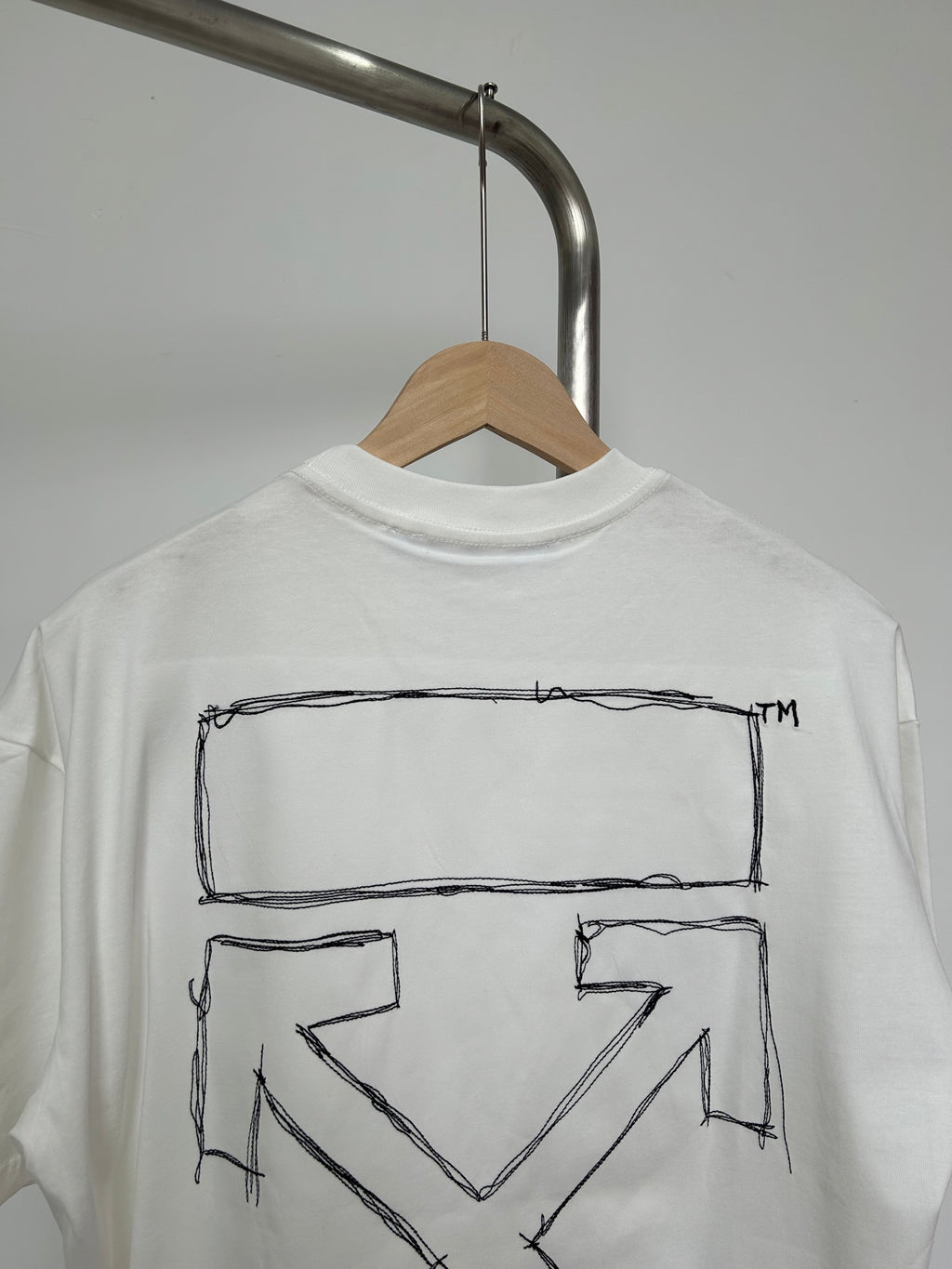 Off-white T-shirt back close view of outlined X chevron graphic