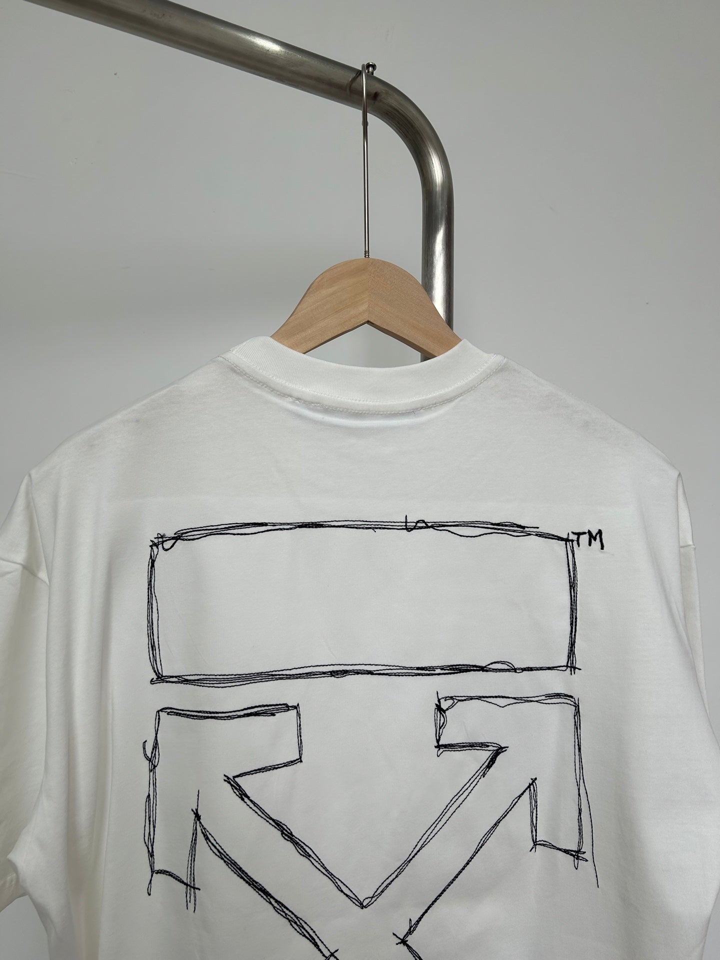 Off-white T-shirt back close view of outlined X chevron graphic