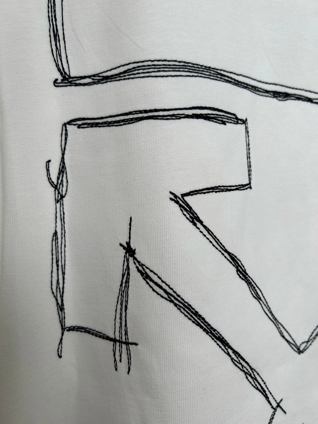Off-white T-shirt back graphic detail of outlined letter “V” shape
