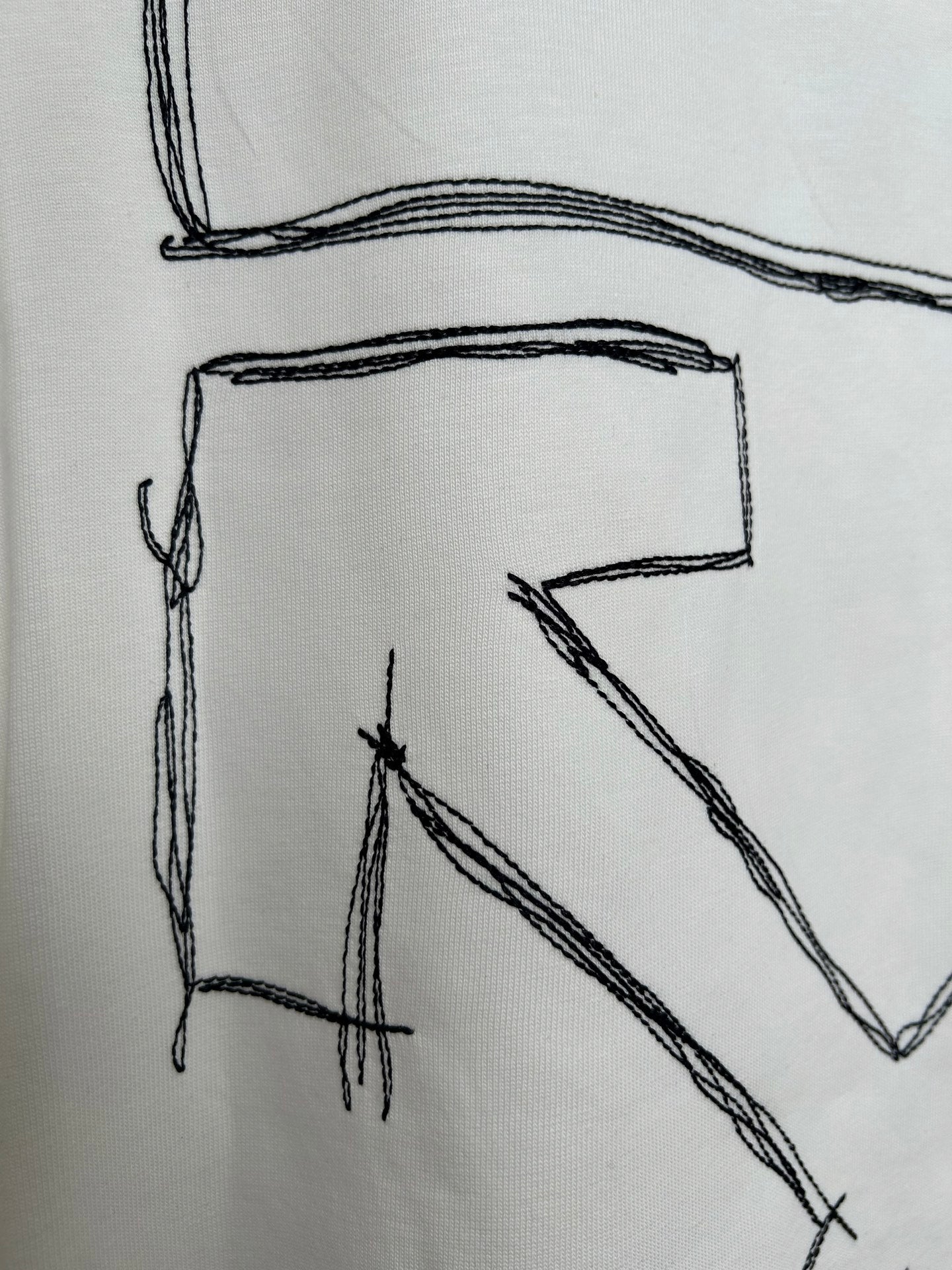 Off-white T-shirt back graphic detail: large letter-like line sketch