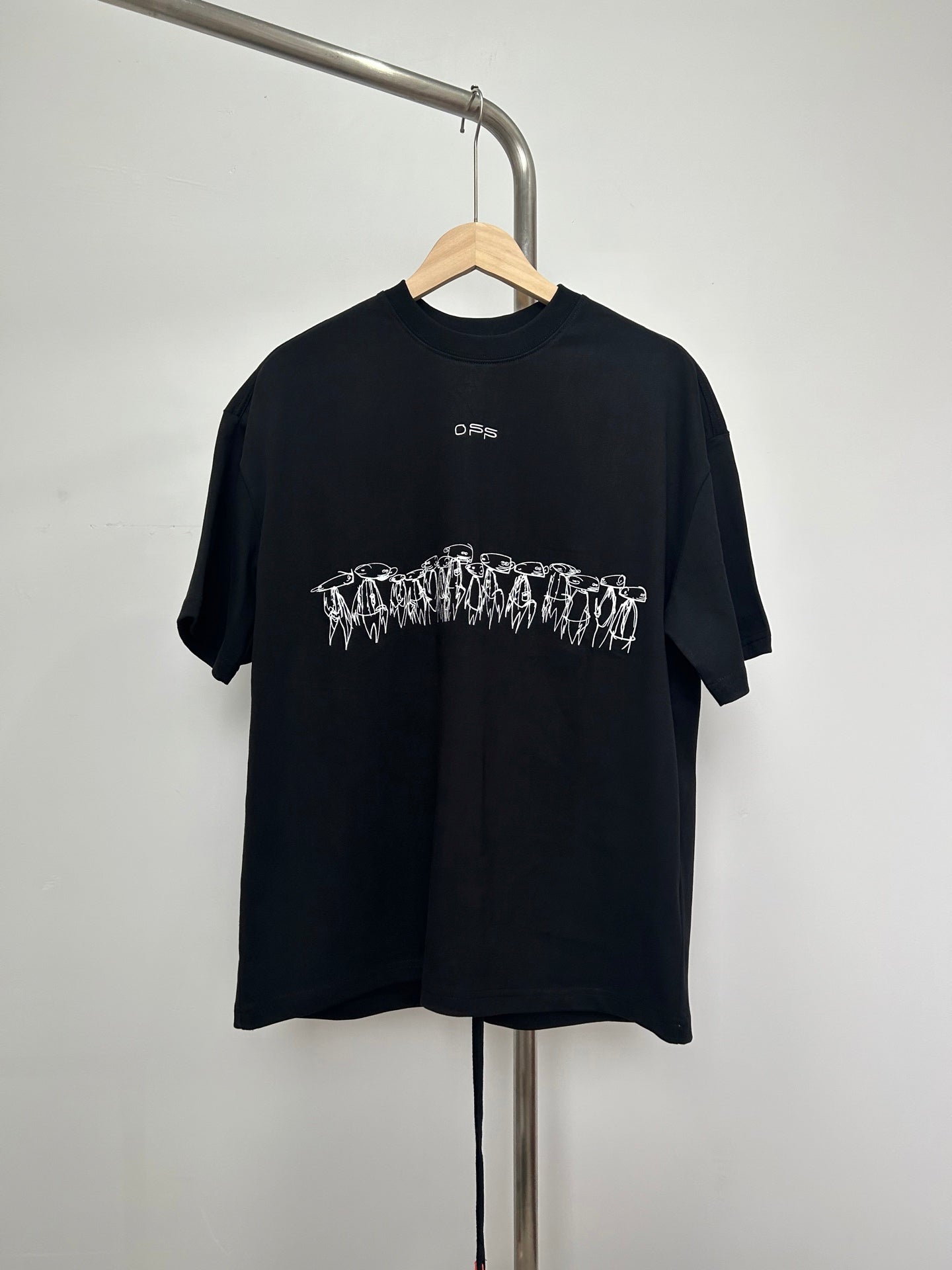 Black graphic T-shirt with white text logo and outlined character print on chest