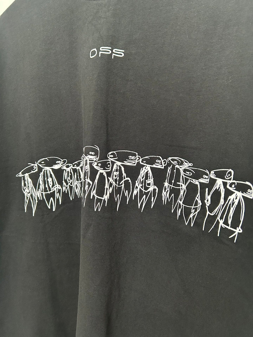 Black T-shirt with white outlined characters band across the front