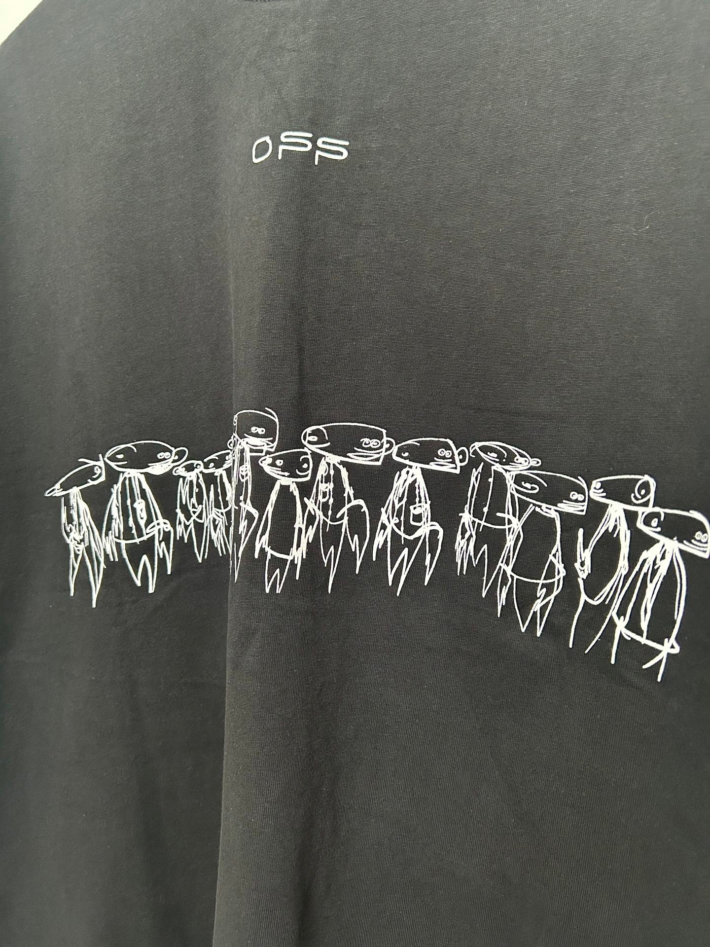 Black T-shirt with white outlined characters band across the front