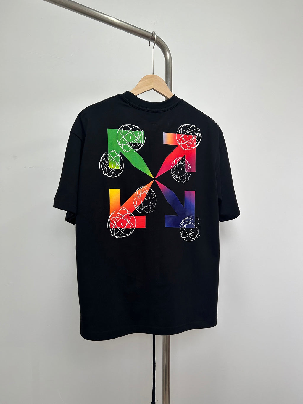 Black T-shirt with colorful geometric orbit and swirl graphic print