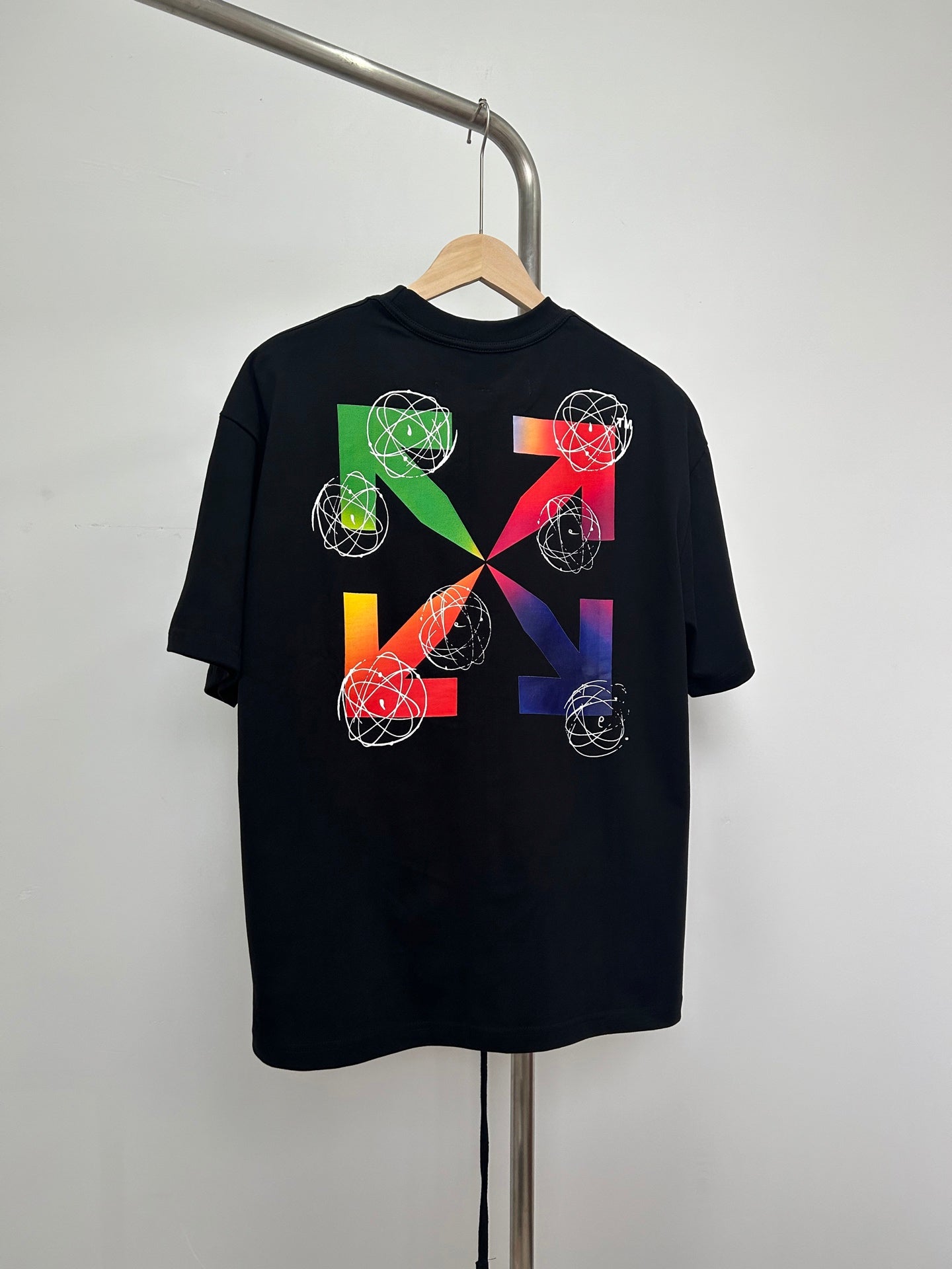 Black T-shirt with colorful geometric orbit and swirl graphic print