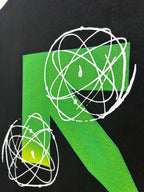 Black T-shirt closeup of green geometric orbit graphic with white outline lines