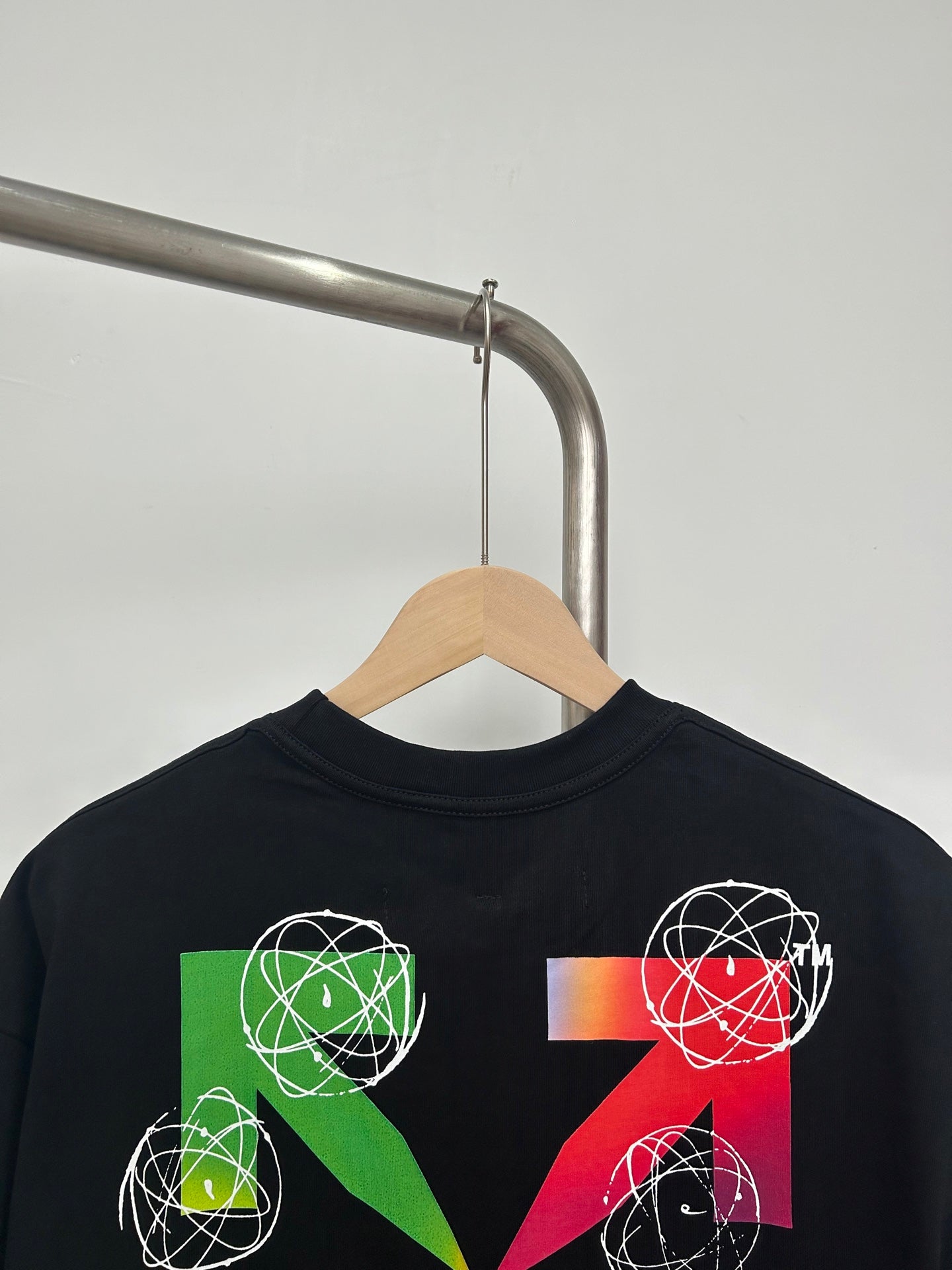 Black T-shirt with colorful geometric orbit graphic on the front