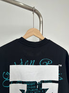 Graphic T-shirt back/upper view with teal script logo and white rectangular overlay