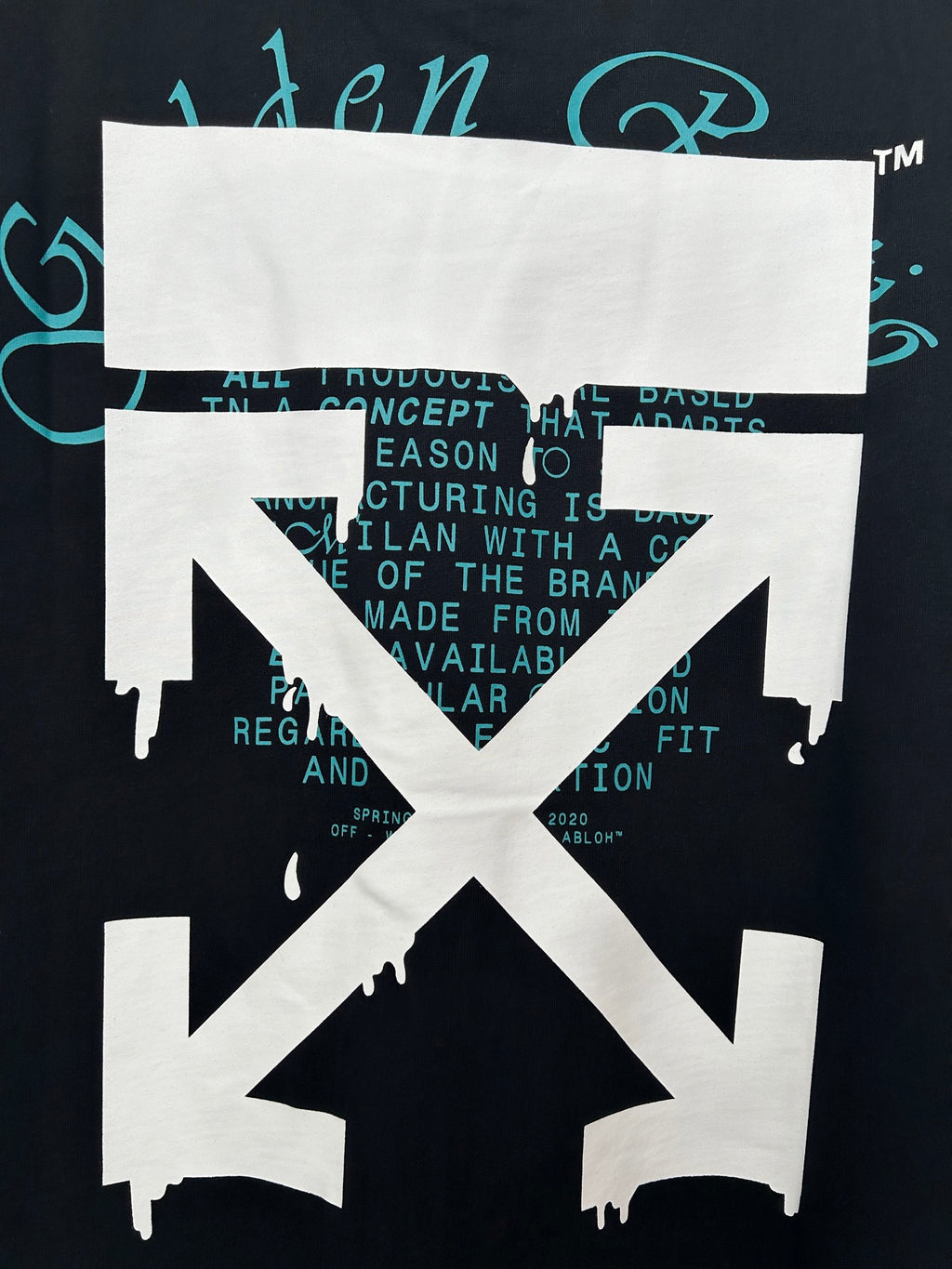 Dark short-sleeve T-shirt front graphic with white X design and teal text