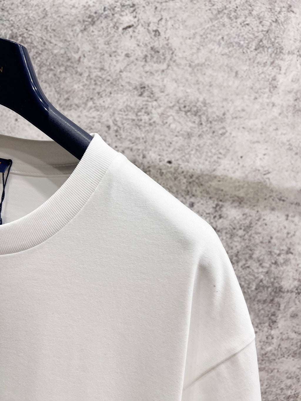 White T-shirt shoulder and sleeve with smooth fabric texture