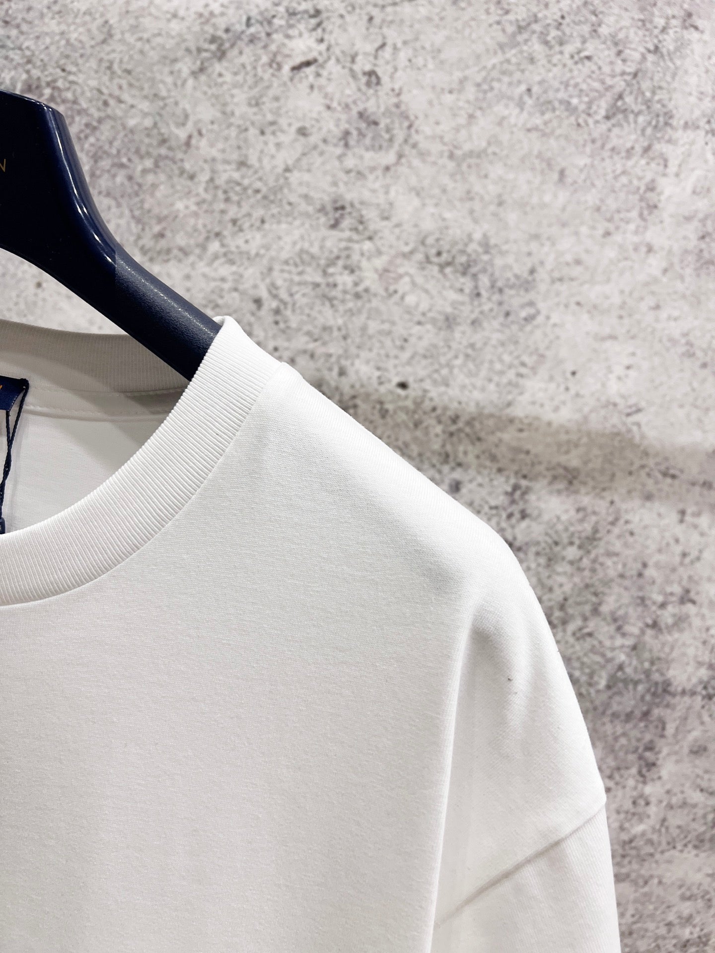 White T-shirt shoulder and sleeve with smooth fabric texture