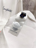 White T-shirt inner care label and Louis Vuitton brand tag inside collar