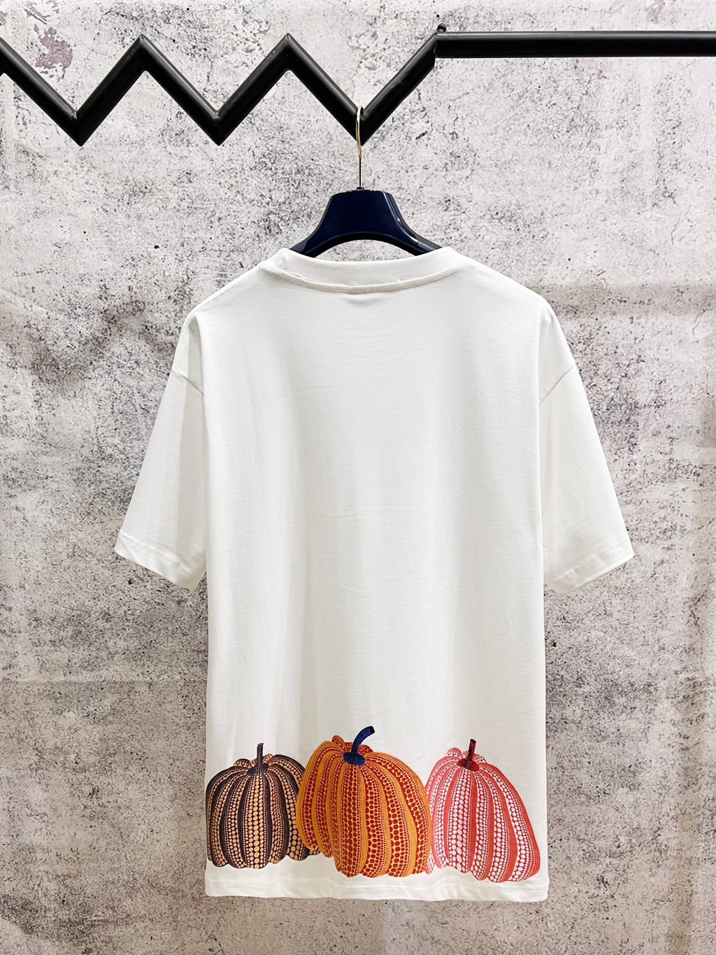 White T-shirt back with Louis Vuitton pumpkin graphic row in brown, orange, and pink
