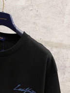Black Louis Vuitton T-shirt with blue logo on the chest, close-up