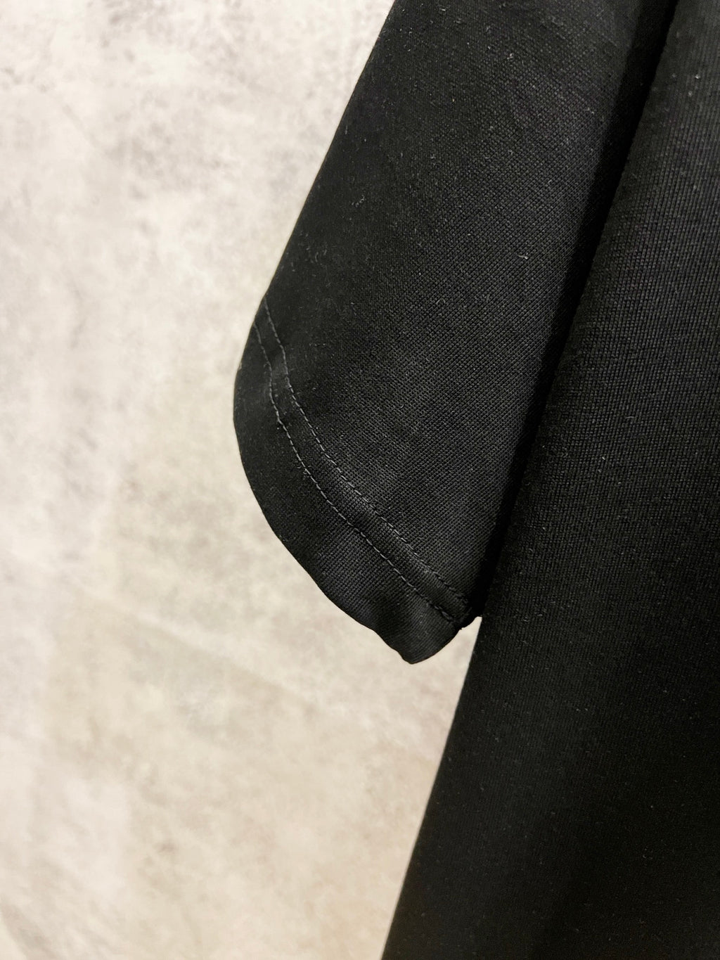 Black Louis Vuitton T-shirt sleeve cuff with visible seam detail