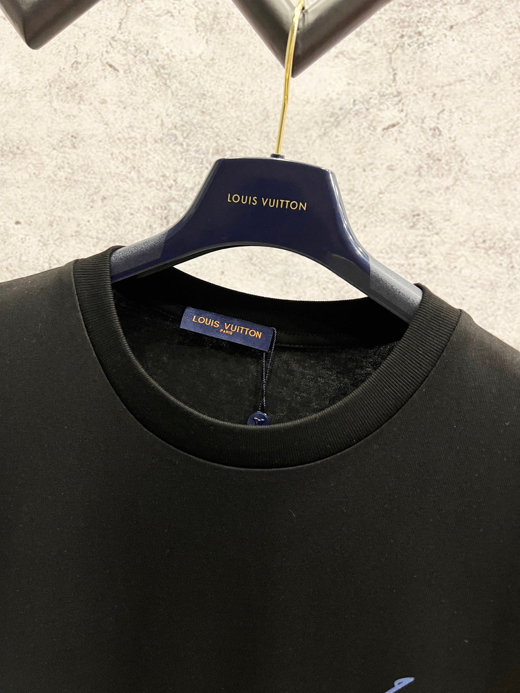 Black Louis Vuitton T-shirt on hanger with round neckline and blue logo
