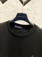Black Louis Vuitton T-shirt on hanger with round neckline and blue logo