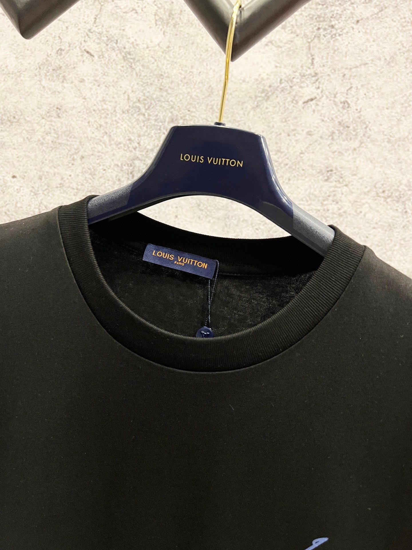Black Louis Vuitton T-shirt on hanger with round neckline and blue logo