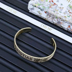 Dior gold-tone cuff bracelet showing engraved band and both open ends